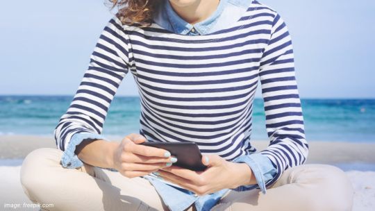 Woman binge-reading on Kindle